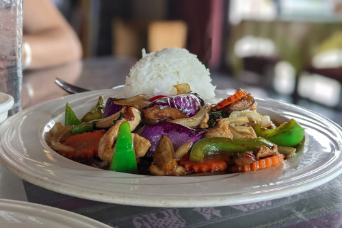 Eggplant with other veggies and chicken in a sauce with rice