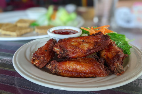 Thai wings appetizer with sauce and salad